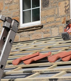 Roofer working up a ladder