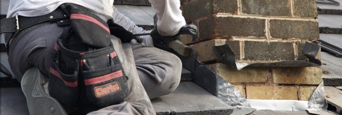 Roofer working with his tools