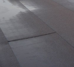 Contractors constructing felt roof